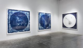 The works in the new exhibit are a combination of paintings and pieces created with a process called cyanotyping. Halloran starts by painting scenes from glass plate images of cosmic objects, taken from the Harvard College Observatory's Astronomical Photo
