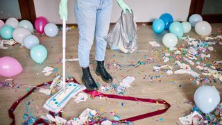 Sweeping up children's party with confetti and balloons