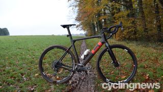 3T Exploro Force in black with red logo pictured on a remote trail near woodland