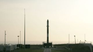 Rocket Lab's Electron rocket stands ready for launch at the Mahia Peninsula in New Zealand, but it will have to wait a few more days to fly while the company conducts additional ground tests.