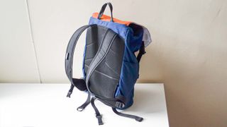 A North St. Belmont in Navy with an Orange flap sitting on a desk
