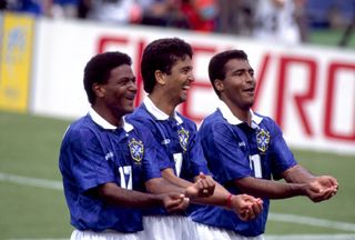 Bebeto performs his famous rocking baby celebration alongside Romario and Mazinho during Brazil's game against the Netherlands at the 1994 World Cup.