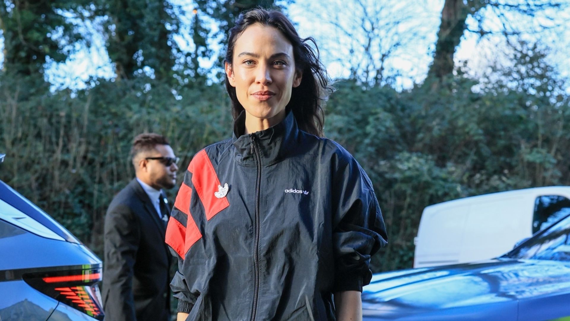 Alexa Chung wears a windbreaker jacket with lace-trim shorts and Miu Miu buckle heels.
