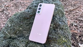 galaxy s22 plus in pink leaning against a rock