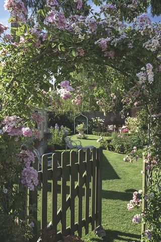 garden gate in an extended Victorian cottage with roses
