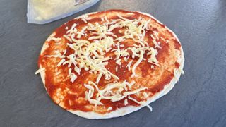 air fryer pizza base loaded with cheese