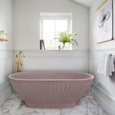 bathroom with fluted pink bathtub and white wall and marble flooring