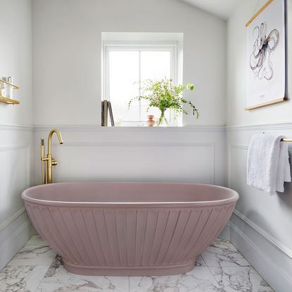 bathroom with fluted pink bathtub and white wall and marble flooring