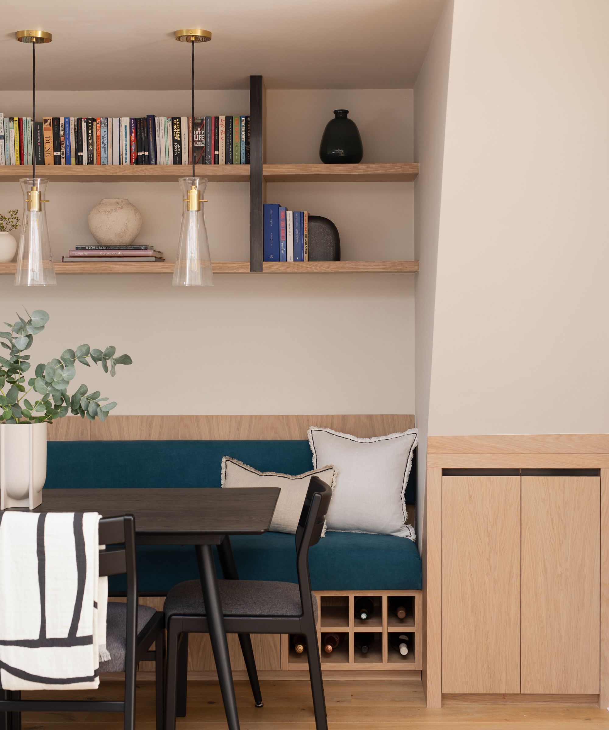 Modern dining room with breakfast nook and navy blue banquette seating