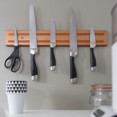 Closeup of kitchen knives on knife magnet
