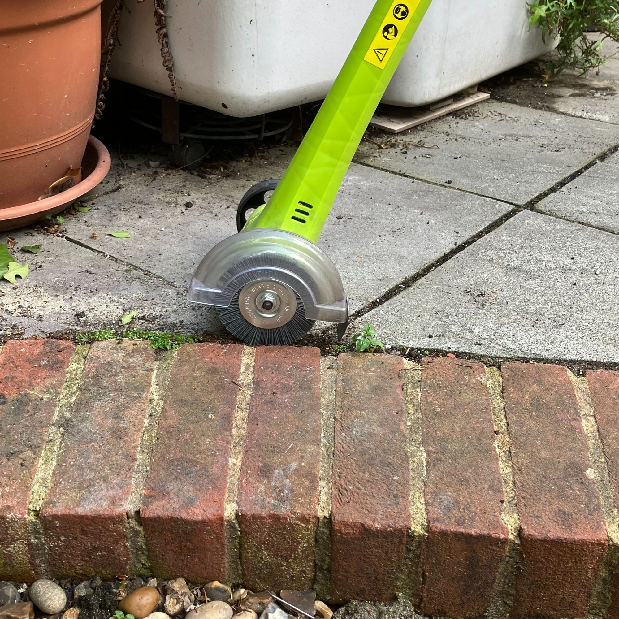 Weed Sweeper tool with brick edging