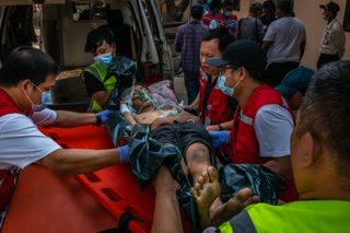 Medics attend to a protester who was shot in Yangon