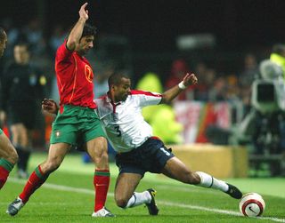 Portugal's Luis Figo (L) fights for the ball with England's Ashley Cole