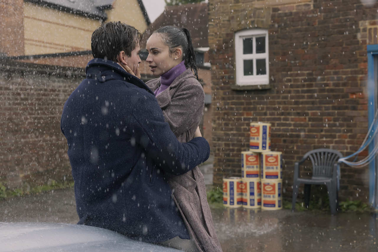 Corey Mylchreest as Jamie and Sofia Carson as Anna in the rain in My Oxford Year.