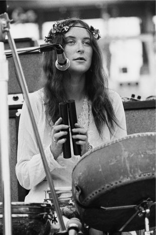 British singer and songwriter Licorice McKechnie playing a pair of claves as her band, The Incredible String Band, perform live at the Woodstock Music and Art Fair in Bethel, New York, 16th August 1969. The four-day music festival was staged on Max Yasgur's dairy farm from 15th to 18th August.