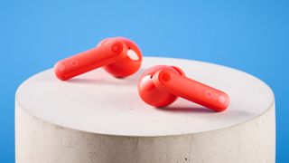 the nothing cmf buds pro 2 cmf by nothing buds pro 2 in bright orange shown in the smart dial charging case against a blue tom's guide background