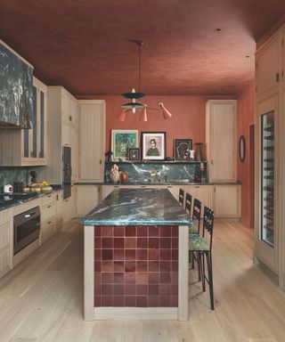 kitchen with brown glazed side tiling on island and green marble countertop