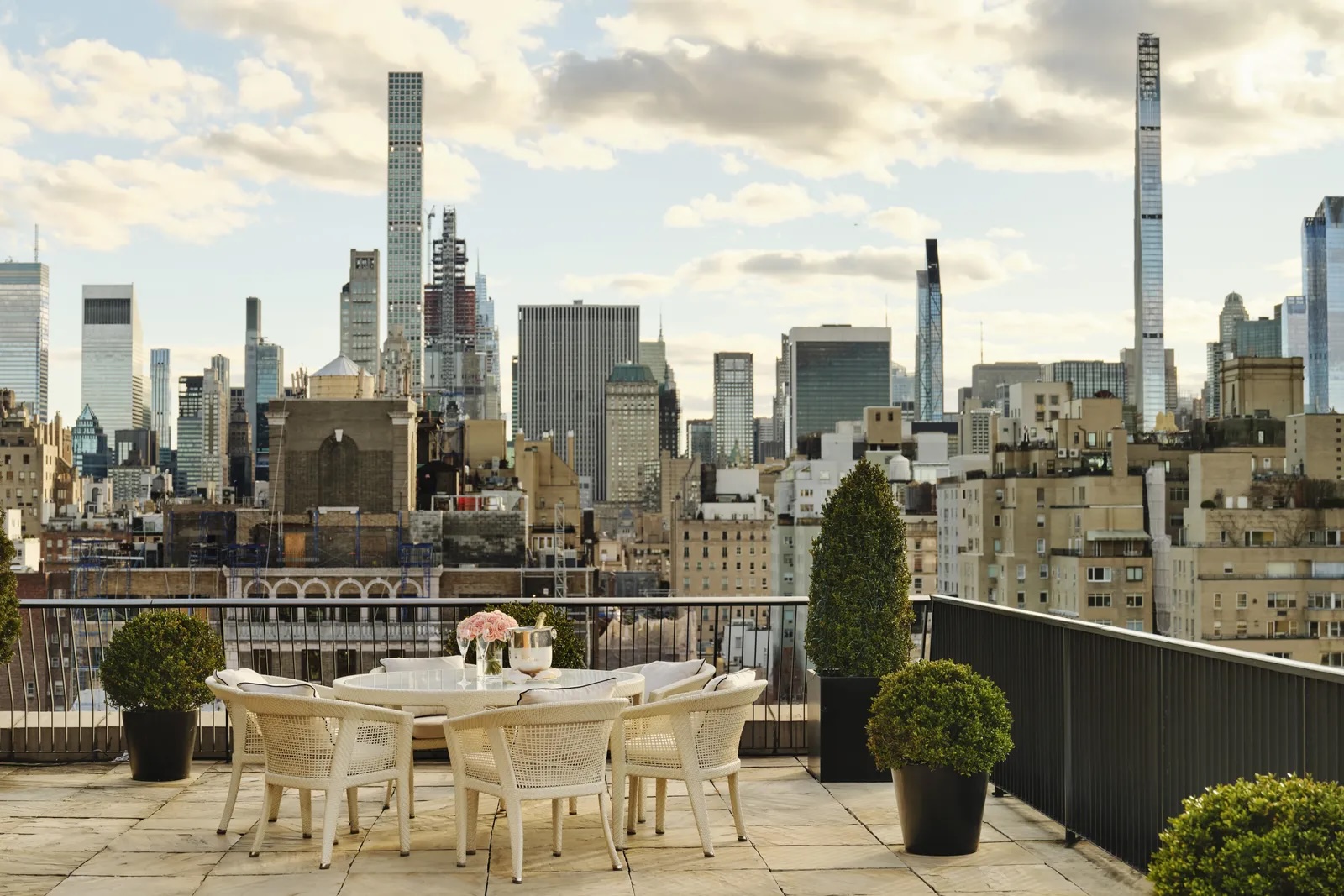 Stone hotel terrace overlooking New York skyline