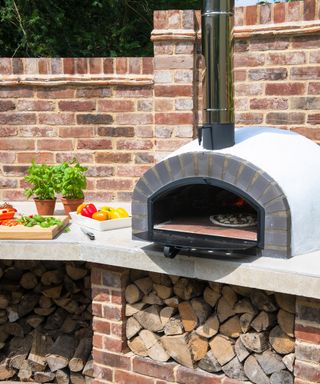 A wood fired pizza oven built into an outdoor kitchen