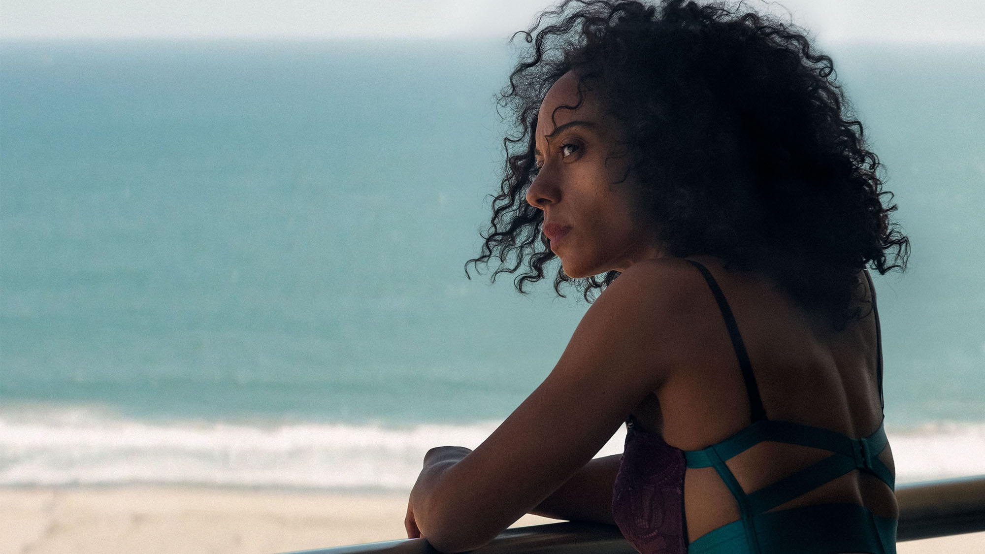Rosalind Eleazar looking out over the ocean in Misty Green