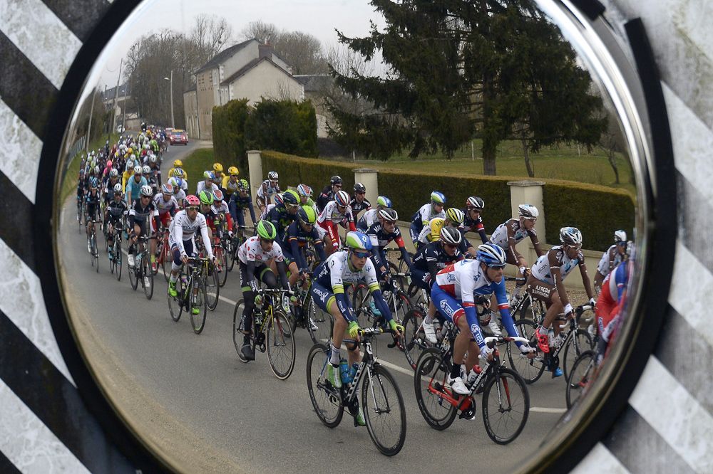 The pack is reflected in a road mirror during the second stage of the 73rd edition of the Paris-Nice.