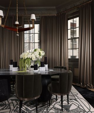 A dining room painted with Sherwin-Williams cocoon, a dark gray-green