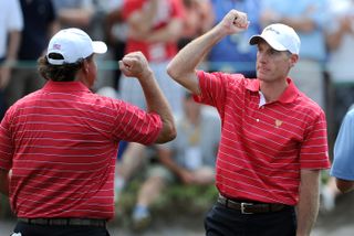 Jim Furyk fist pumps Phil Mickelson during the 2011 Presidents Cup