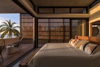 a bedroom with a wooden screen to create privacy