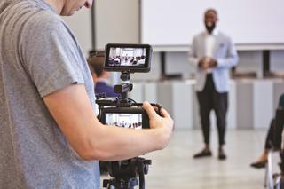 Shot of a man using a camera to shoot a corporate event