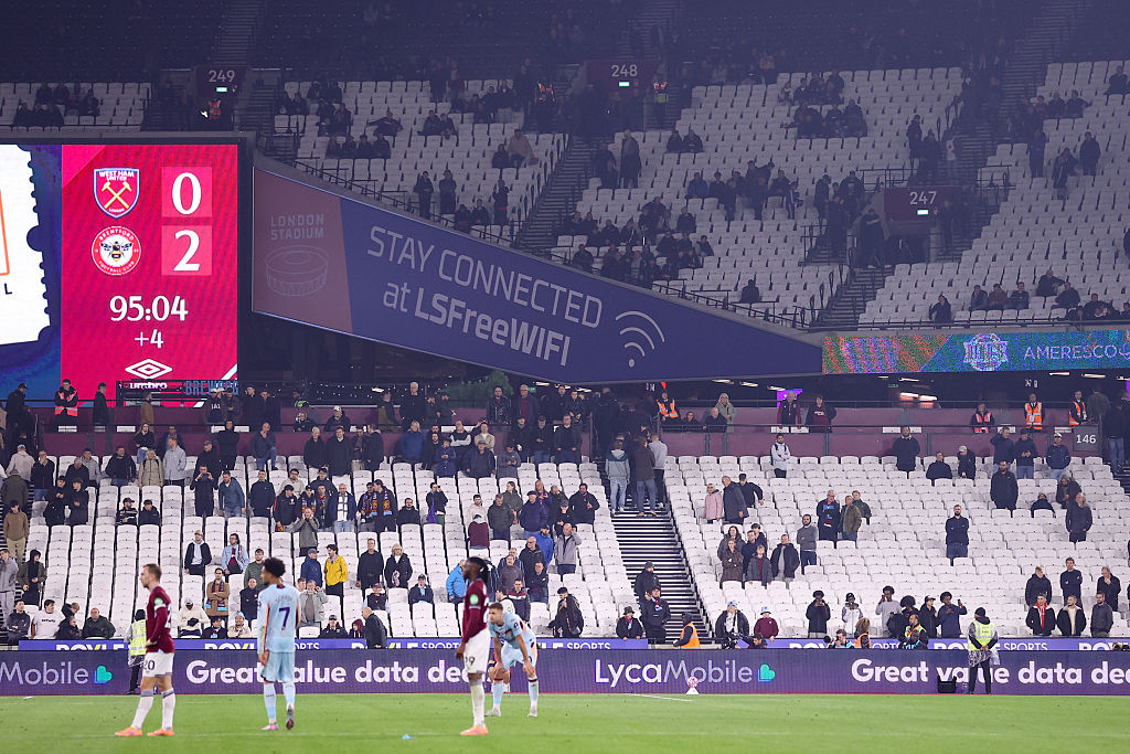 West Ham fans stream out of the ground after Brentford score their second goal during the Premier League match between West Ham United and Brentford at London Stadium on October 20, 2025 in London, England.