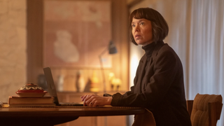 Anna Maxwell Martin as Lucy Betts-Taylor, sitting at a desk with a laptop, in Ludwig