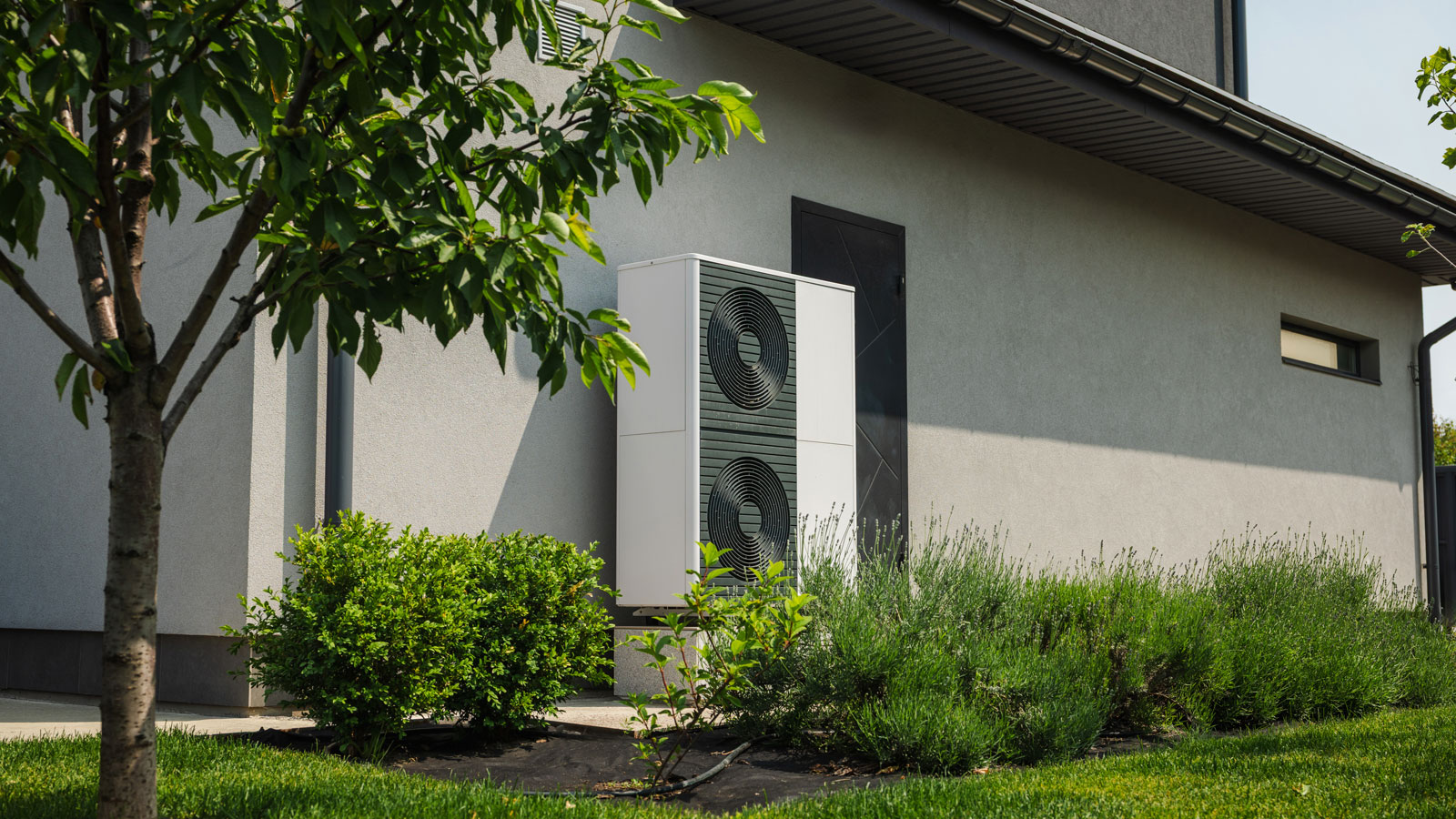 heat pump located on the side of a contemporary house