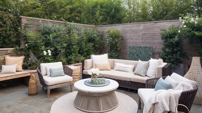 A backyard layout with soft furnishings and coffee table