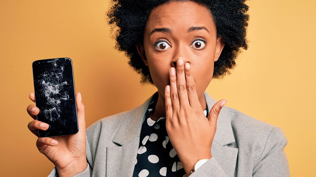 Woman holding a broken mobile phone