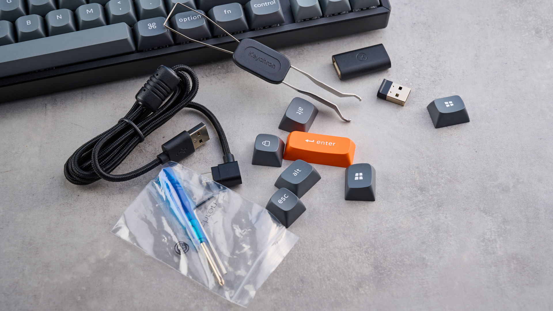 Keychron K8 Max mechanical keyboard in gray photographed on a blue background