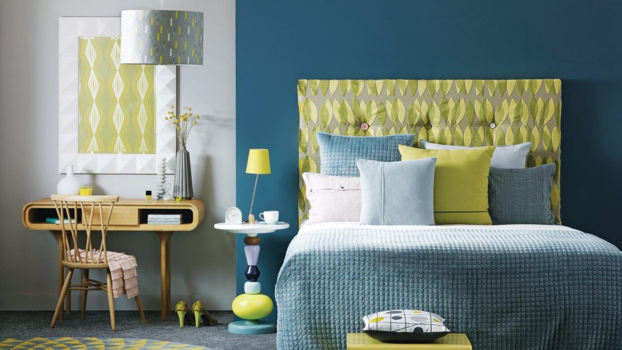 Blue bedroom with green furnishings designed to help get sleep schedule back on track