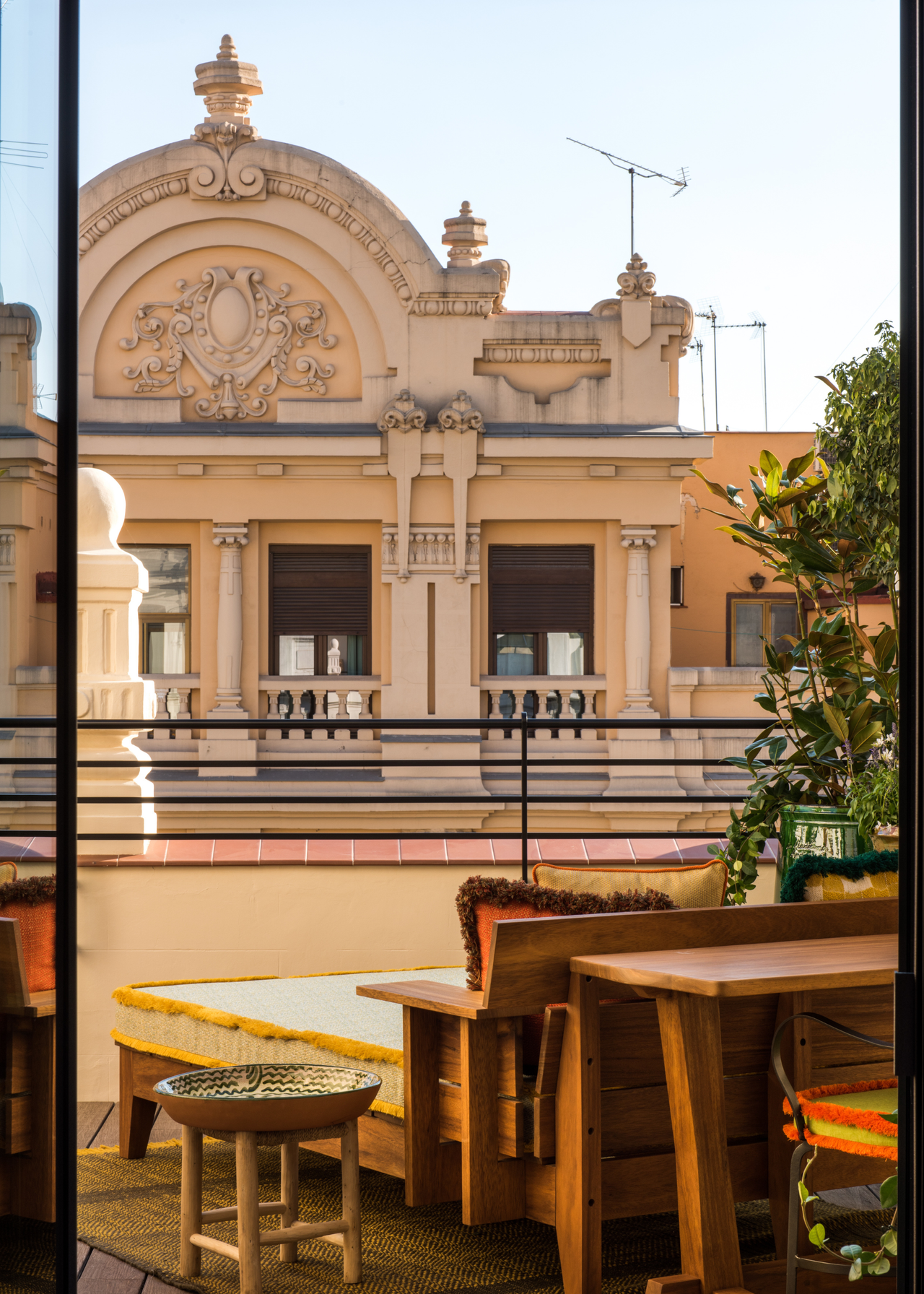 A balcony attached to a hotel room looking out onto an architectural building