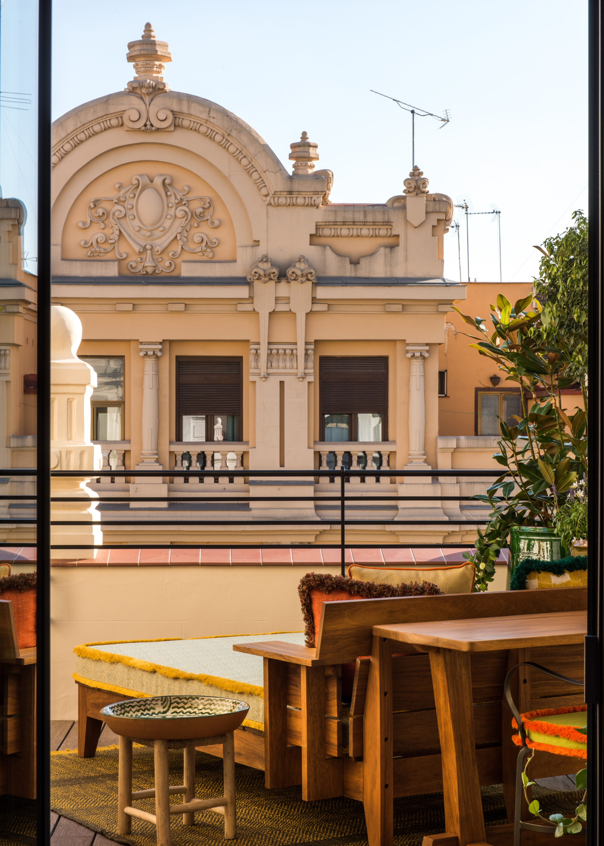 A balcony attached to a hotel room looking out onto an architectural building