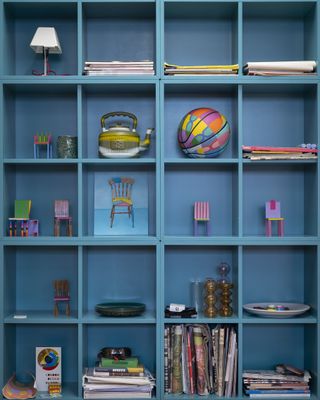 Blue shelves in Yinka Ilori's studio
