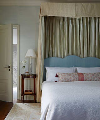 bedroom with headboard and drapes