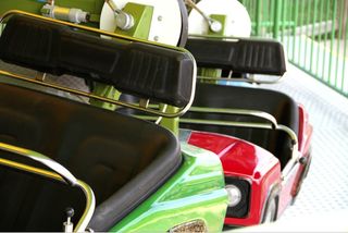 Bumper cars lined up at an amusement park.