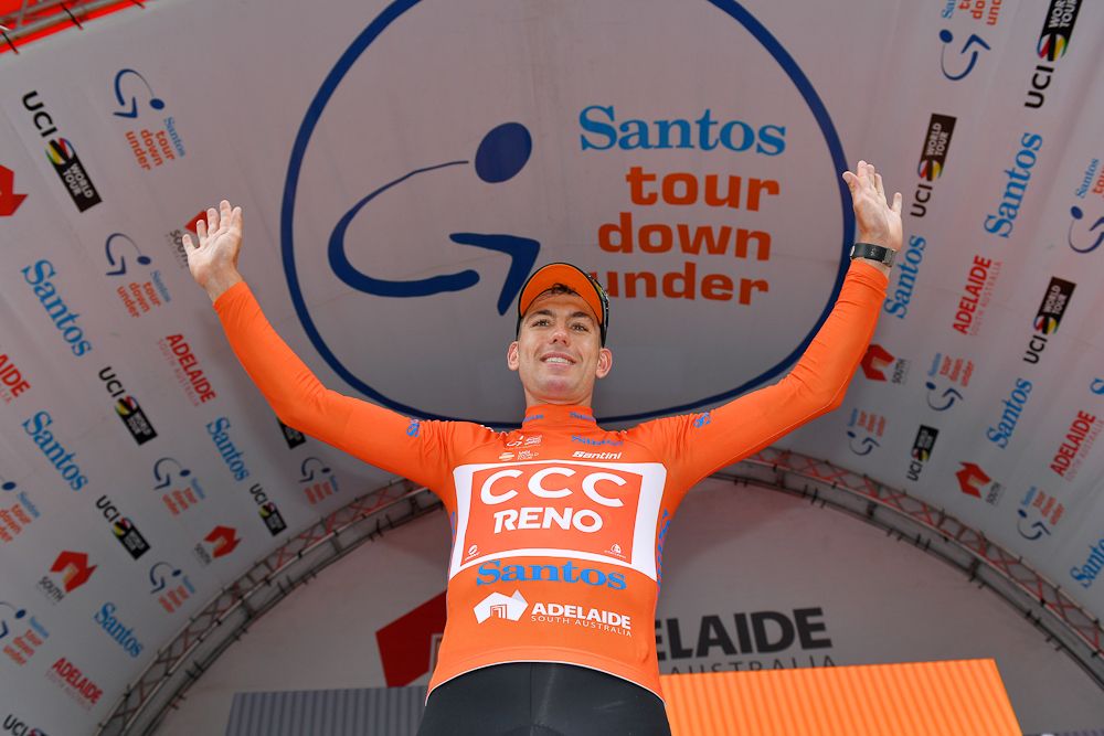 Patrick Bevin celebrates on the Tour Down under podium after wining stage 2 and taking the overall lead