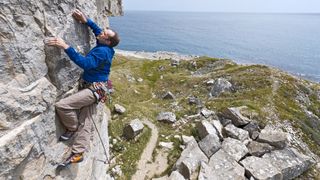 A guide to climbing rating systems: climber on a limestone crag