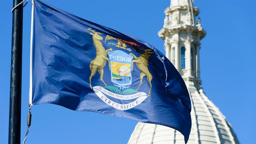 State flag of Michigan flying in front of its Capitol building