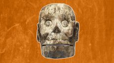 front aspect of a wood mask carved like a skull from the Aztec culture