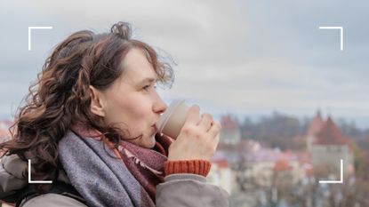 Woman holding a disposal thermal cup standing outside, representing looking after gut health in winter