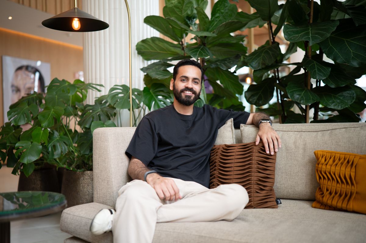 Portrait of a man sat on a sofa in a plush hotel