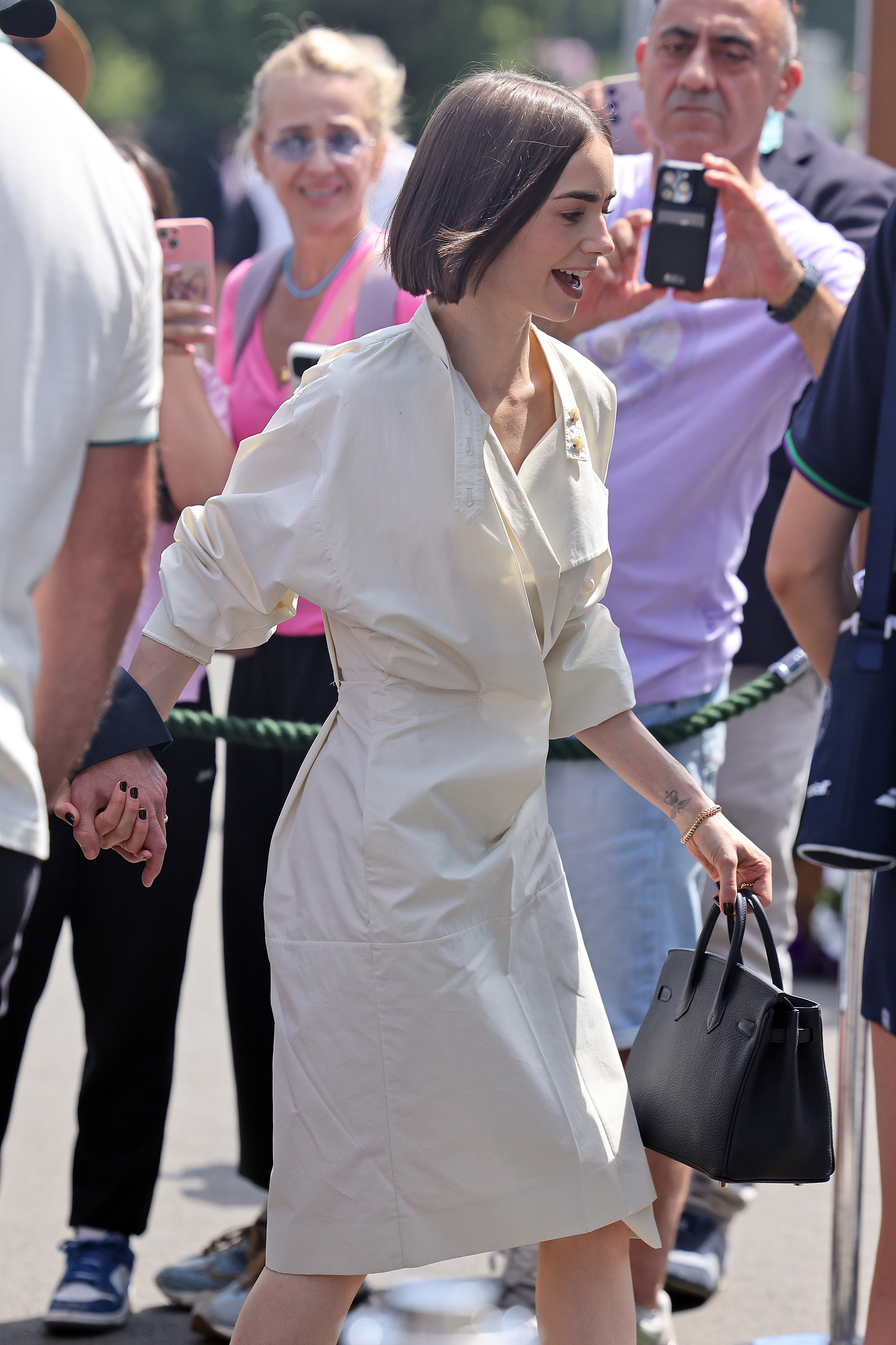 Lily Collins wearing black nail polish