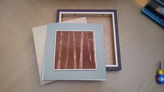 Glowforge Pro review shows a trees engraved into a piece of wood sat on a picture frame