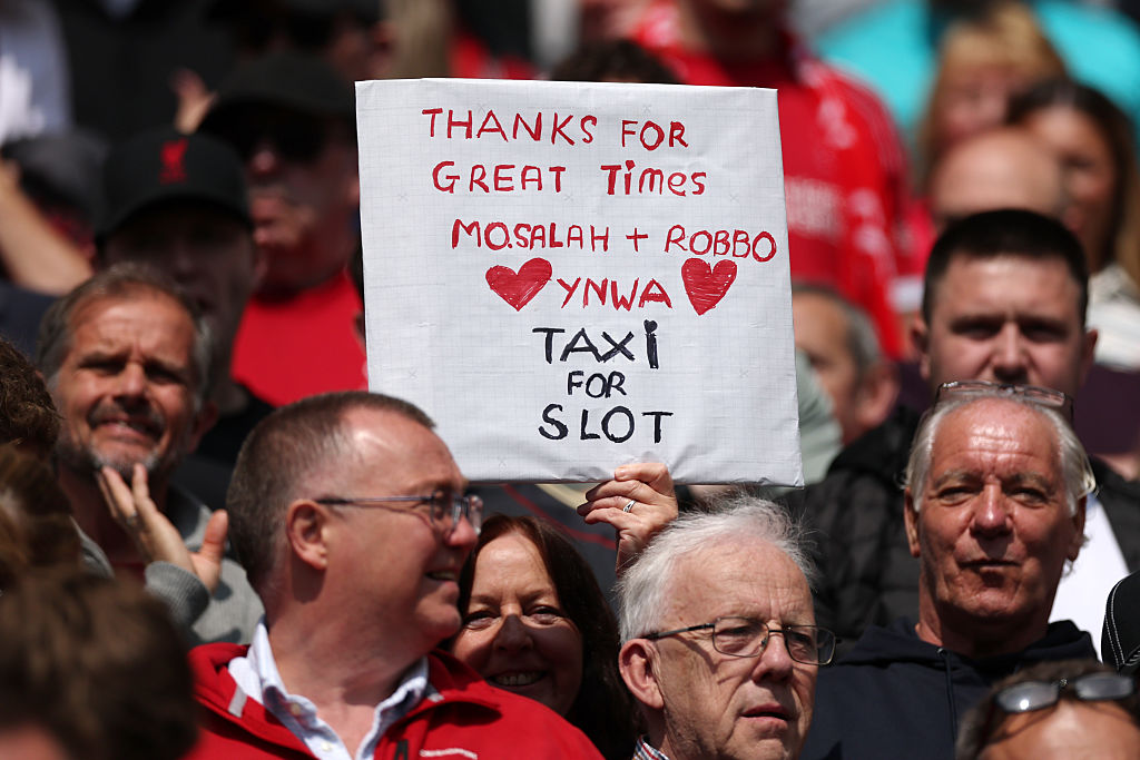 A fan of Liverpool holds up a sign which reads "Thanks for great times, mo.Salah + Robbo, YNWA, Taxi for slot" prior to the Premier League match between Liverpool and Chelsea at Anfield on May 09, 2026 in Liverpool, England.